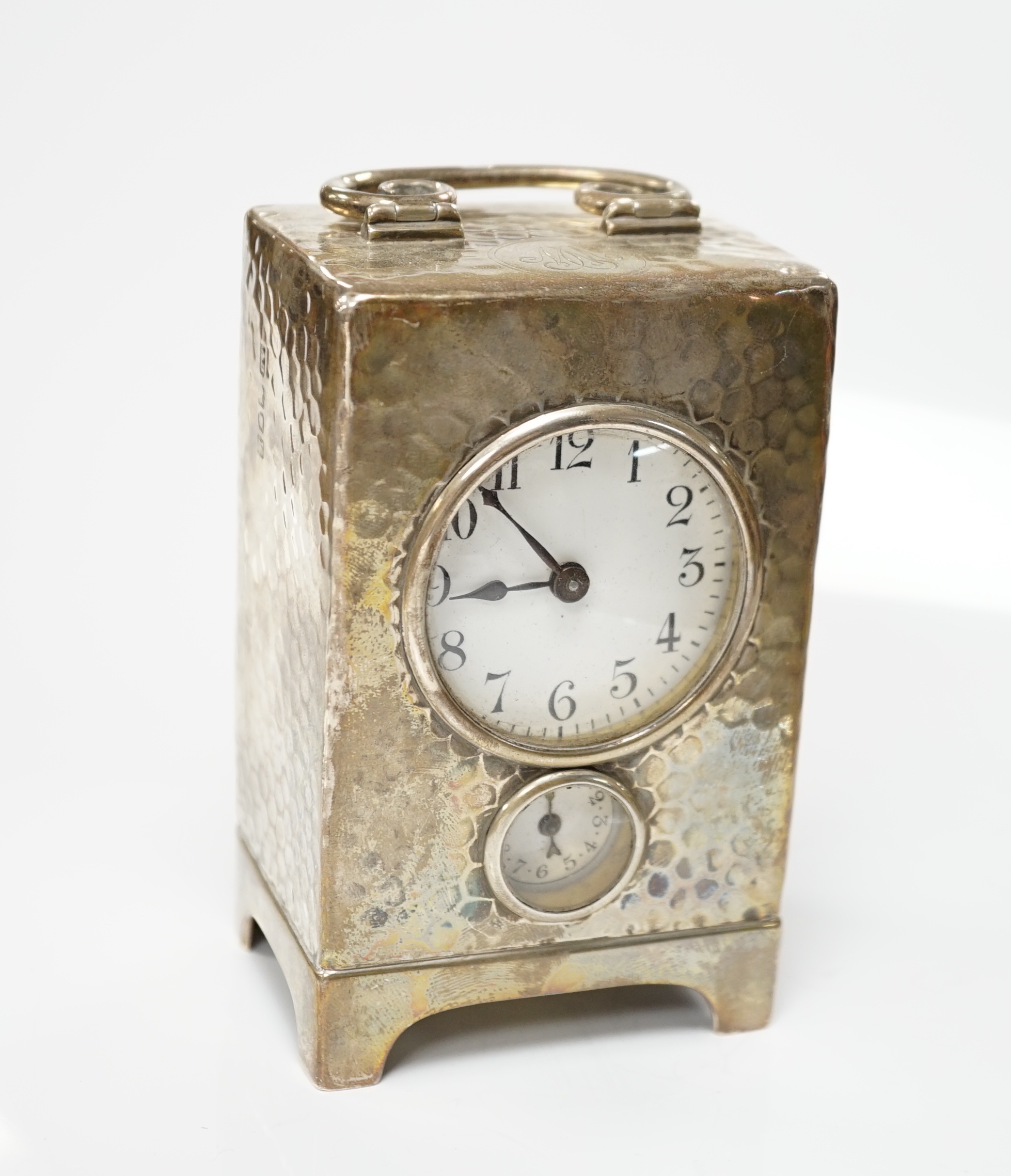 An Edwardian planished silver alarm carriage timepiece, Arthur Baume & Co, London, 1905, height 11cm.